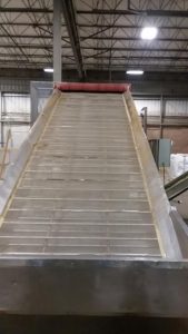 moving ramp thatpulls product into large dryer